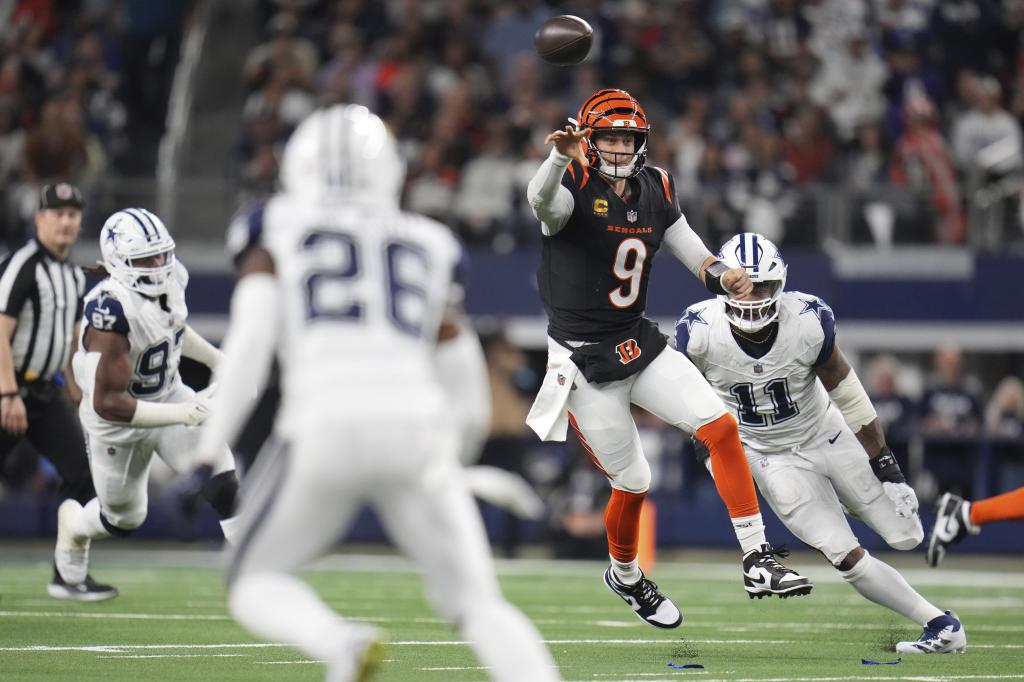 Cincinnati Bengals quarterback Joe Burrow (9) throws as Dallas Cowboys linebacker Micah Parsons (11) moves in during the first half of an NFL football game, Monday, Dec. 9, 2024, in Arlington, Texas. (AP Photo/Julio Cortez)