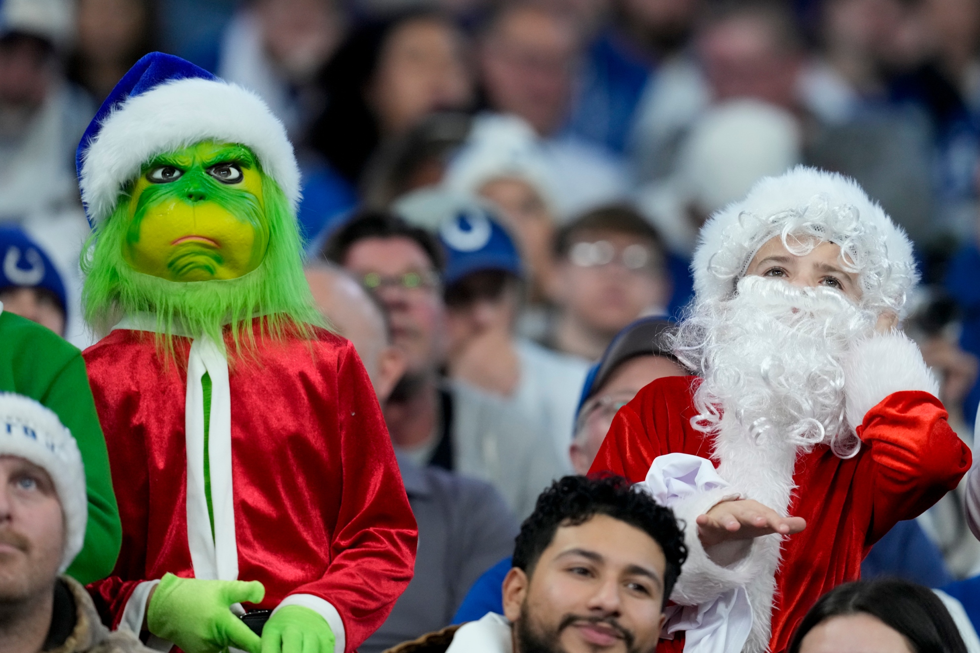 The Grinch and Santa Claus, sharing the stands.